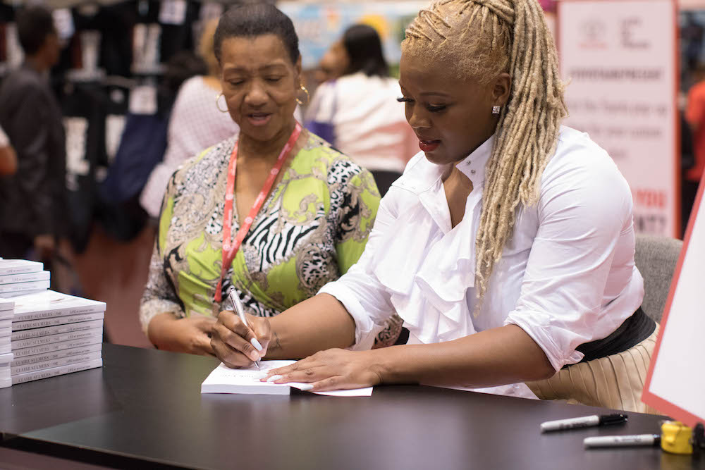 leadership-signing-copies-of-the-bomb-life-at-the-toyota-booth-at-the-national-urban-league-wearing-luxe-protocol-claire-sulmers-fashion-bomb-daily-jpg